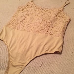 Nude with lace thong bodysuit.